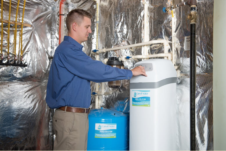 Carroll Water Technician performing maintenance on an Ecowater System